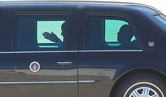 President Obama (right) rides in his limousine on the apron at General Mitchell International Airport in Milwaukee on Wednesday, June, 30, 2009, after attending a town-hall meeting in Racine, Wis. (AP Photo/Jeffrey Phelps) 