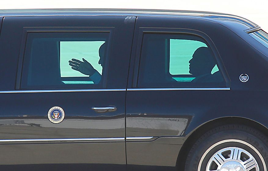 President Obama (right) rides in his limousine on the apron at General Mitchell International Airport in Milwaukee on Wednesday, June, 30, 2009, after attending a town-hall meeting in Racine, Wis. (AP Photo/Jeffrey Phelps)