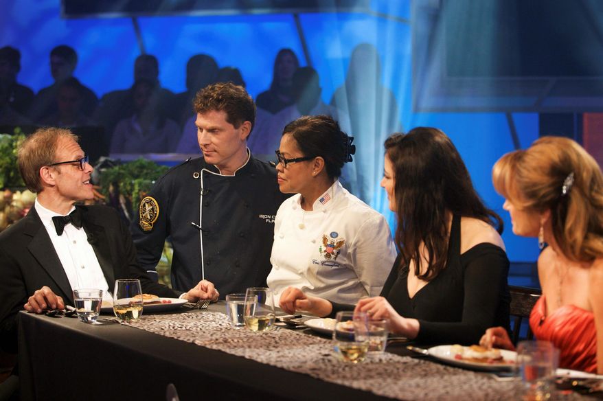 Food Network via Associated Press
Alton Brown (from left) talks with chef teammates Bobby Flay and the White House's executive chef, Cristeta Comerford, at the judging table in Kitchen Stadium in New York. Mrs. Comerford paired with Mr. Flay to win the "Iron Chef America" battle over chefs Emeril Lagasse and Mario Batali.