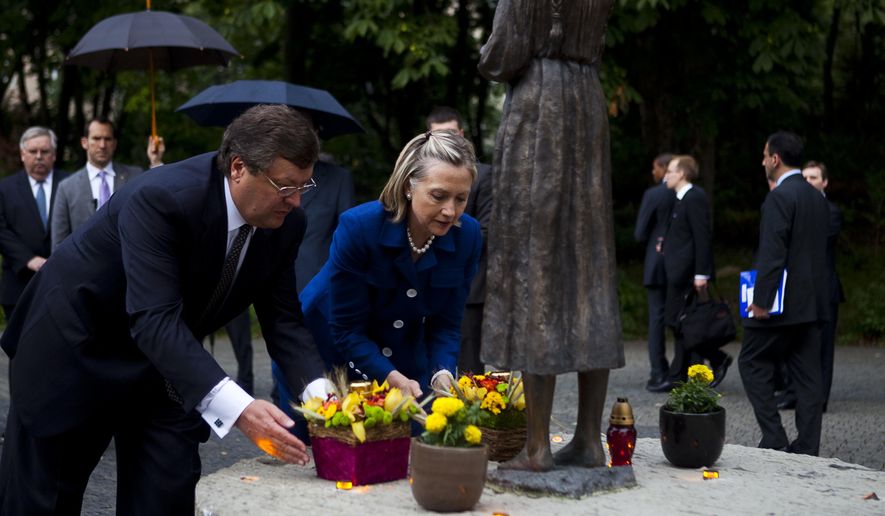 Hillary Clinton and Ukrainian Foreign Minister Kostyantyn Gryshchenko laid flowers at a memorial in Kiev in 2010. Recent news suggests the Ukrainian government and the Democratic National Committee planted seeds to try to stop Donald Trump from winning the presidential election. (Associated Press/File)