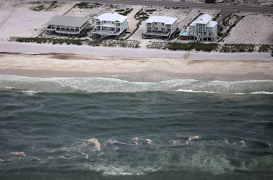 A huge oil slick approaches the beach in Gulf Shores, Ala., Friday, July 2, 2010. Oil from the Deepwater Horizon incident is expected to come ashore over the July 4th weekend. (AP Photo/Dave Martin)
