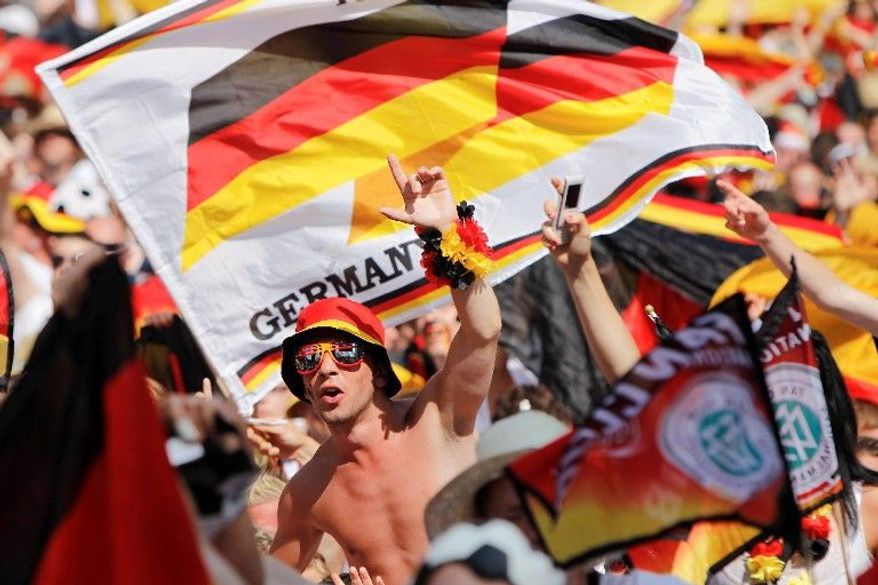 Fans of Germany's soccer team show their pride in Berlin before the quarterfinal World Cup match between Argentina and Germany on Saturday. (Associated Press)