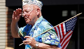 Pearl Harbor survivor Cecil Malmin salutes during the 4th of July parade Sunday, July 4, 2010, in Alameda, Calif. (AP Photo/Ben Margot)