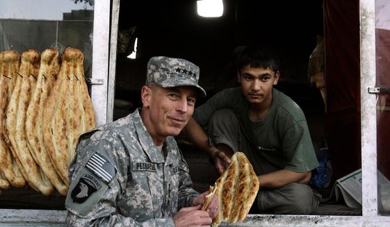 Gen. David H. Petraeus, the new commander of U.S. and NATO forces in Afghanistan, grabs a bite at a bakery in Kabul, Afghanistan. President Obama said about Gen. Petraeus, &quot;I&#39;m extraordinarily grateful that he has agreed to serve in this new capacity.&quot; (Associated Press)
