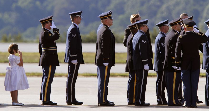 A family member of the late Sen. Robert Byrd, follows the honor guard carrying his casket at it arrived on a West Virginia Air National Guard C-130 transport plane by an honor guard at Yeager Airport in Charleston, W.Va., Thursday, July 1, 2010. Mr. Byrd was being buried at a cemetery in Arlington, Va., on Tuesday, July 6, 2010. (AP Photo/Steve Helber)