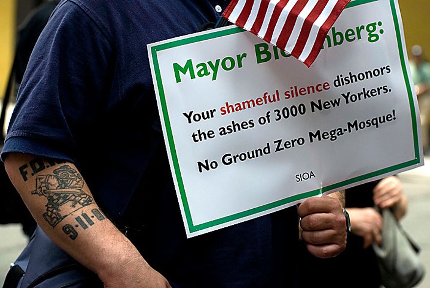 A man attending the protest of the proposed construction of a mosque near ground zero holds a sign directed at New York's Mayor near the World Trade Center site in New York Sunday, June 6, 2010. (AP Photo/Swoan Parker)