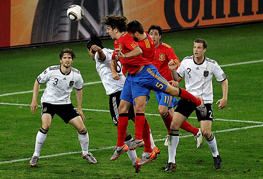 Spain's Carles Puyol, front, heads the ball to score a goal during the World Cup semifinal soccer match between Germany and Spain at the stadium in Durban, South Africa, Wednesday, July 7, 2010.. (AP Photo/Hassan Ammar)