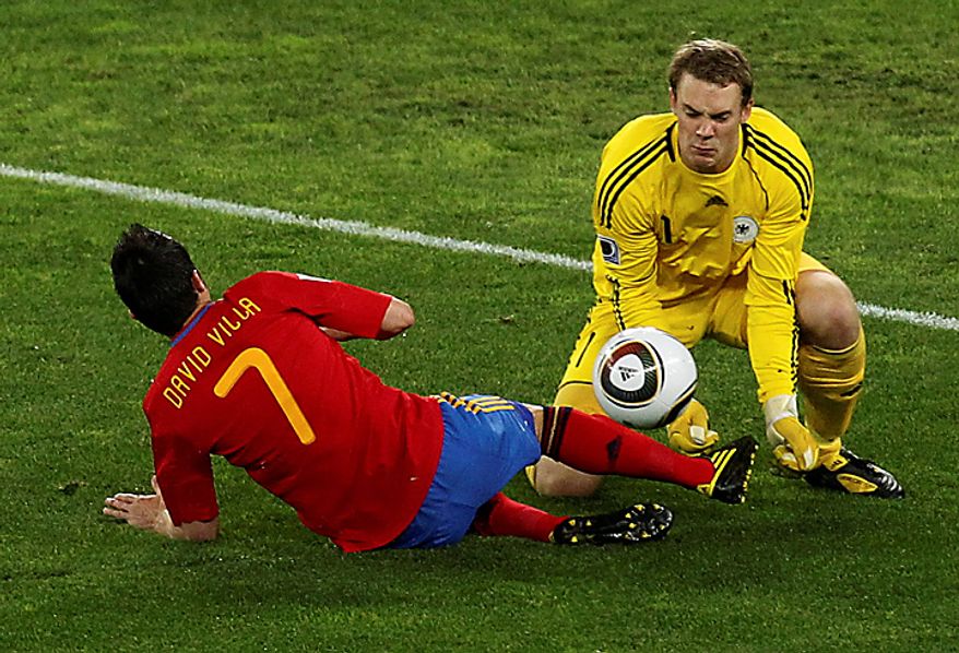 Germany goalkeeper Manuel Neuer, right, saves on Spain's David Villa's shot, during the World Cup semifinal soccer match between Germany and Spain at the Moses Mabhida stadium in Durban, South Africa, Wednesday July 7, 2010. (AP Photo/Themba Hadebe)