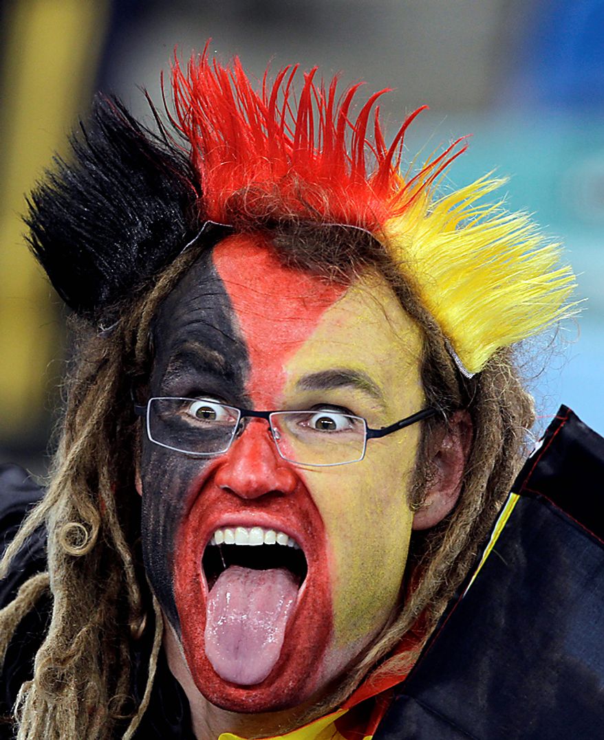 A German fan sticks his tongue out prior to the World Cup semifinal soccer match between Germany and Spain at the stadium in Durban, South Africa, Wednesday, July 7, 2010. (AP Photo/Gero Breloer)