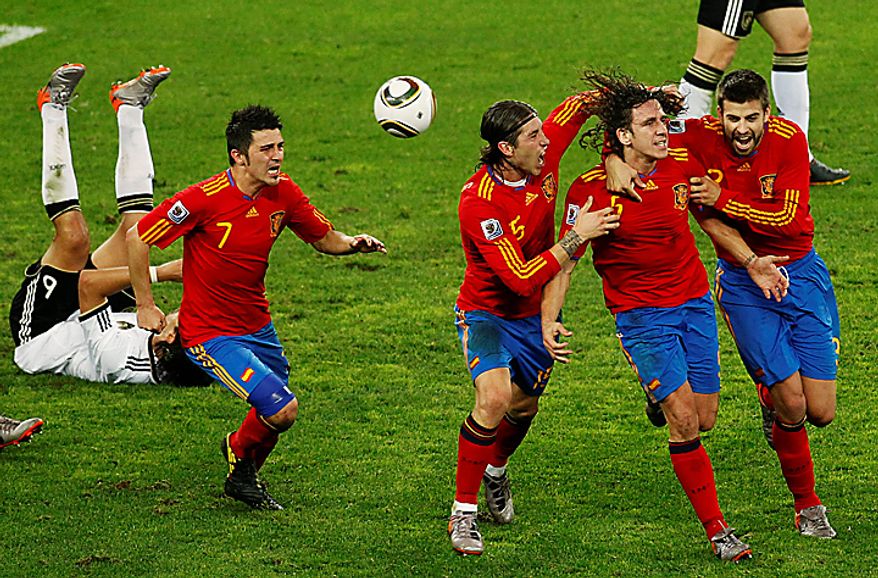Spain's Carles Puyol, second from right, celebrates after scoring a goal with teammates Gerard Pique, right, Carles Puyol, third from right, and David Villa, second from left, during the World Cup semifinal soccer match between Germany and Spain at the Moses Mabhida stadium in Durban, South Africa, Wednesday July 7, 2010. Spain won 1-0.(AP Photo/Themba Hadebe)