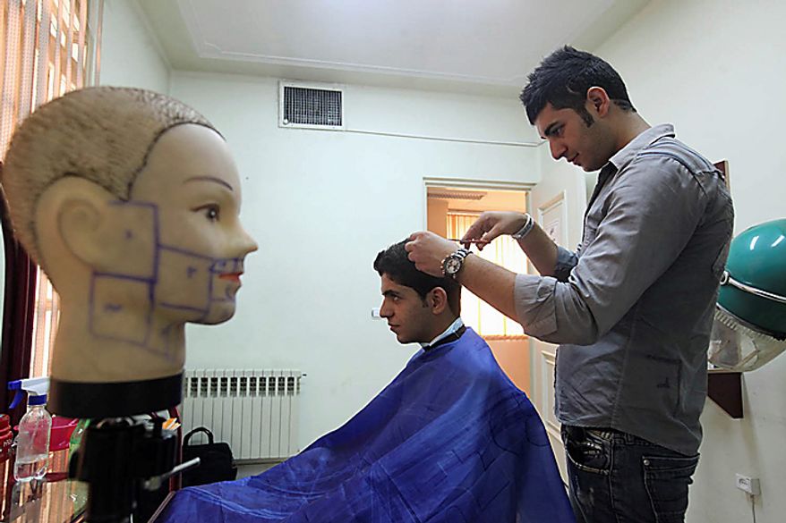 In this picture released by the semi-official Iranian Mehr News Agency, a barber cuts hair in an official hairdressing show for men culturally appropriated by the Iran's Ministry of Culture and Islamic Guidance, in Tehran, Iran, on Monday, July 5, 2010. An Iranian fashion organization has issued a new list of culturally appropriate haircuts for men, possibly indicating a new crackdown on male attire after years of strict rules for women, Iranian media reported. (AP Photo/Mehr News Agency, Mohsen Rezaei/HO)