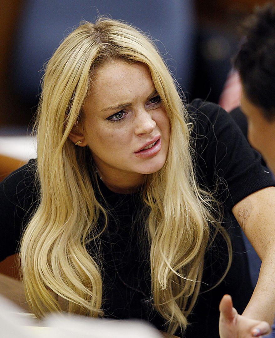 Actress Lindsay Lohan (L) and attorney Shawn Chapman Holley appear in court during a probation status hearing relating to her August 2007 no contest pleas to two counts each of DUI and being under the influence of cocaine, along with a reckless driving charge, at the Beverly Hills Municipal Courthouse, in Beverly Hills, California on July 6, 2010. UPI/David McNew/Pool