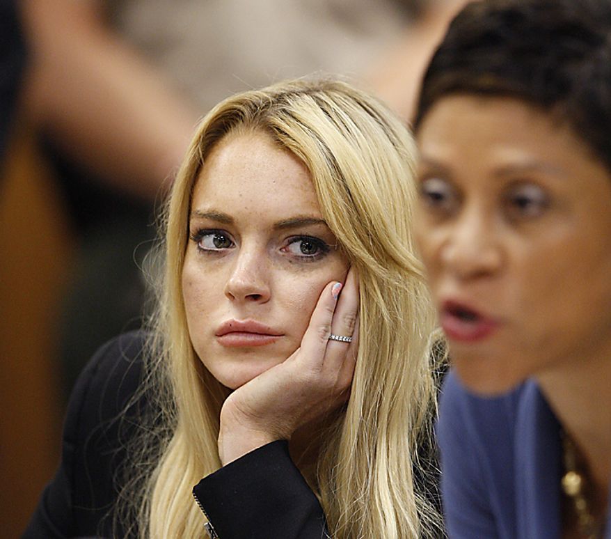 Actress Lindsay Lohan (L) and attorney Shawn Chapman Holley appear in court during a probation status hearing relating to her August 2007 no contest pleas to two counts each of DUI and being under the influence of cocaine, along with a reckless driving charge, at the Beverly Hills Municipal Courthouse, in Beverly Hills, California on July 6, 2010. UPI/David McNew/Pool
