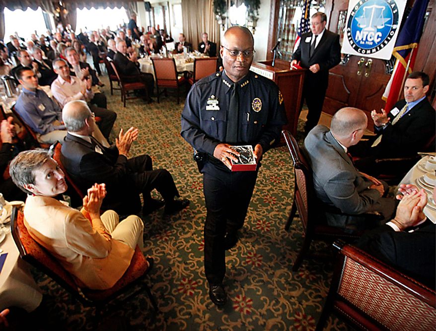 Dallas Police Chief David Brown receives a round of applause after addressing a breakfast meeting Wednesday July 7, 2010 of the North Texas Crime Commission at the Park Cities Club, in Dallas. Brown is resuming his public duties more than two weeks after his son was killed. An autopsy found that David Brown Jr. had marijuana and PCP in his system when he fatally shot Lancaster police Officer Craig Shaw and neighbor Jeremy McMillan on June 20. The Father's Day shootings took place during a domestic dispute at an apartment complex. Officers returned fire and killed Brown Jr. (AP Photo/The Dallas Morning News, Jim Mahoney)