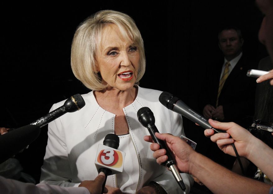 ** FILE ** In this June 15, 2010 file photo, Arizona Gov. Jan Brewer speaks in Phoenix. Donations to a special fund that Arizona Gov. Jan Brewer established to help pay for the state's legal defense of its immigration enforcement law now total roughly $500,000. (AP Photo/Ross D. Franklin, File )