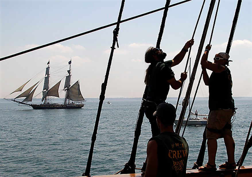 Crewmen on the HMS Bounty trim their sails as the USS Niagara sails past on Lake Erie off Cleveland Wednesday, July 7, 2010. The Bounty, built for the 1961 movie "Mutiny on the Bounty," is one of 11 tall ships that will be in the city for a weekend festival. (AP Photo/Mark Duncan)