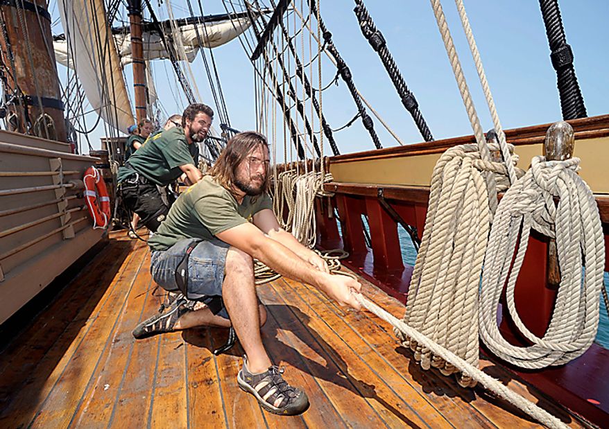Zack Lash, right, and Rich O'Connor haul on a halyard on the HMS Bounty on Lake Erie off Cleveland, Wednesday, July 7, 2010. The sailing ship, built for the 1961 movie "Mutiny on the Bounty," is one of 11 tall ships that will be in the city for a weekend festival. (AP Photo/Mark Duncan)