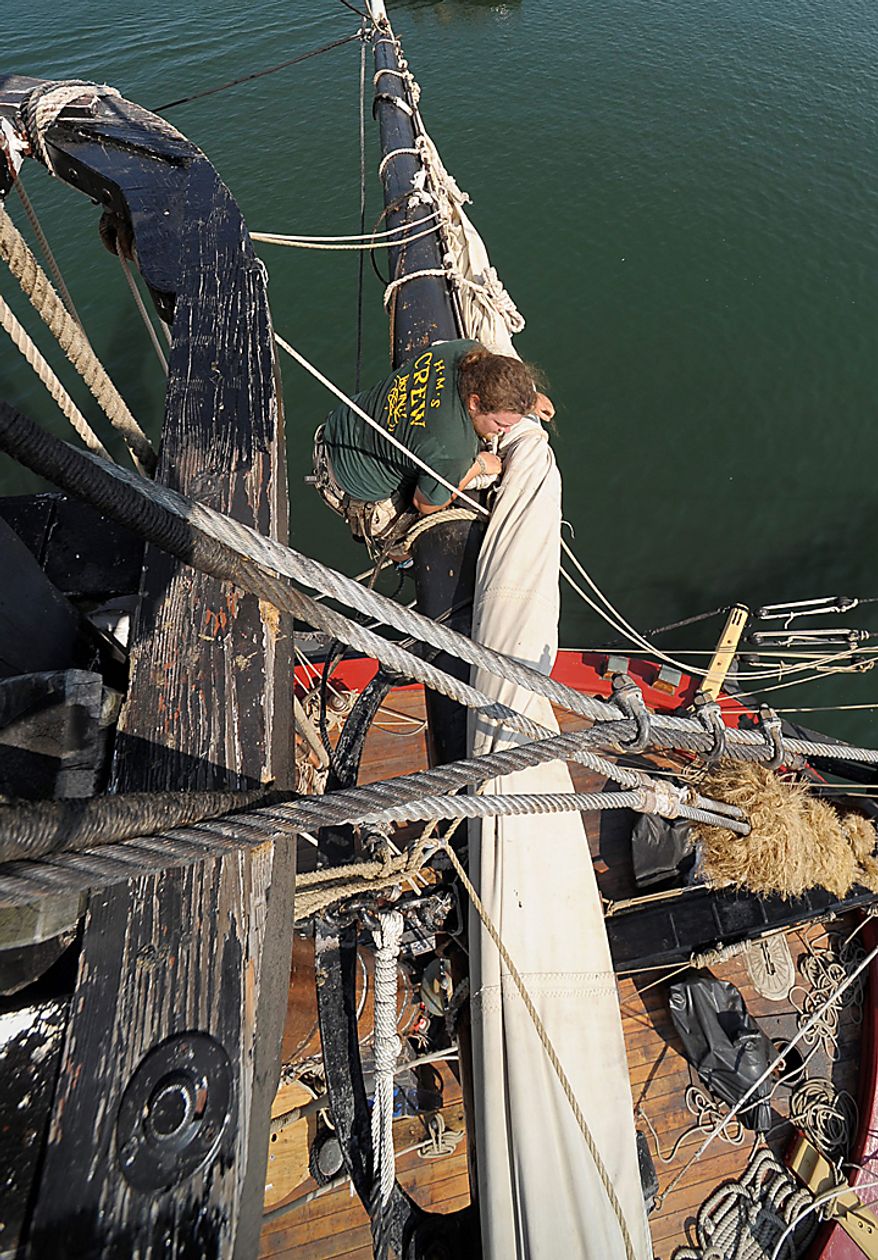 Jesse Ludke loosens a sail on the HMS Bounty before departing Cleveland for Lake Erie, Wednesday, July 7, 2010. The sailing ship, built for the 1961 movie "Mutiny on the Bounty," is one of 11 tall ships that will be in the city for a weekend festival. (AP Photo/Mark Duncan)