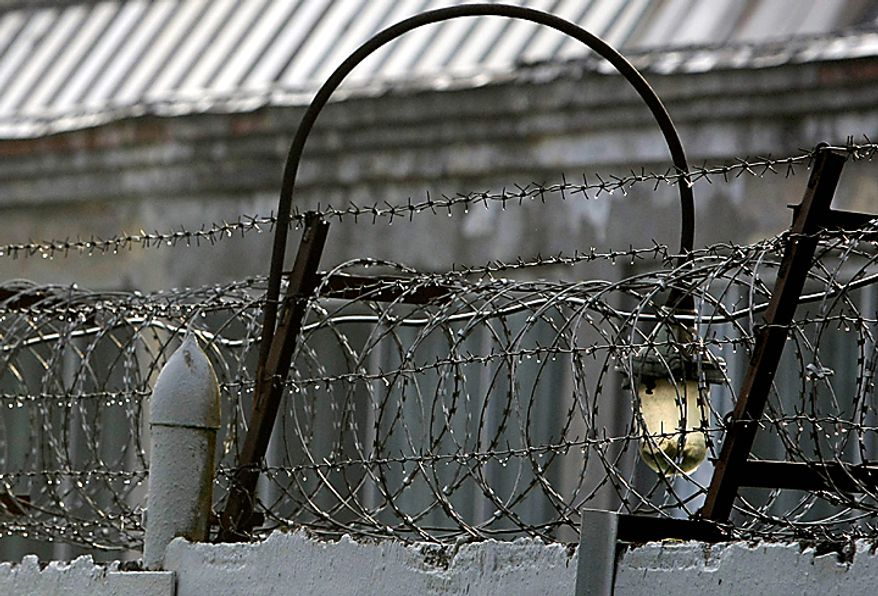 A barbed wire is seen over a fence of the Lefortovo prison in Moscow, Thursday, July 8, 2010. Riot police on Thursday secured the perimeter of the prison, and convoy of armored vehicles arrived in the morning at the prison, thought to be the central gathering point for people convicted of spying for the West, including nuclear researcher Igor Sutyagin, serving a 14-year sentence for spying for the United States. (AP Photo/Misha Japaridze)(AP Photo/Misha Japaridze)