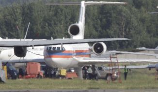 Russian plane believed to be carrying candidates for a 14-person spy swap, is seen at Moscow&#39;s Domodedovo airport, on Friday, July 9, 2010. The plane carrying the colours of the Russian Ministry of Emergency Situations is thought to have flown from Austria on Friday, following an exchange of spies between Moscow and Washington. (AP Photo/Sergey Ponomarev)