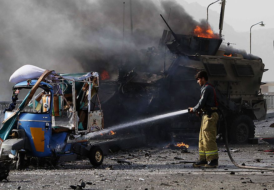 A U.S. military vehicle burns after it was hit by a blast in Jalalabad, east of Kabul, Friday, July 9, 2010. Afghan official said that a suicide car bomb hit the convoy and that one person was killed and nine were wounded. A NATO spokeswoman confirmed an explosion hit a coalition convoy but said she had been told it was a homemade bomb, not a suicide attacker. (AP Photo/Rahmat Gul)