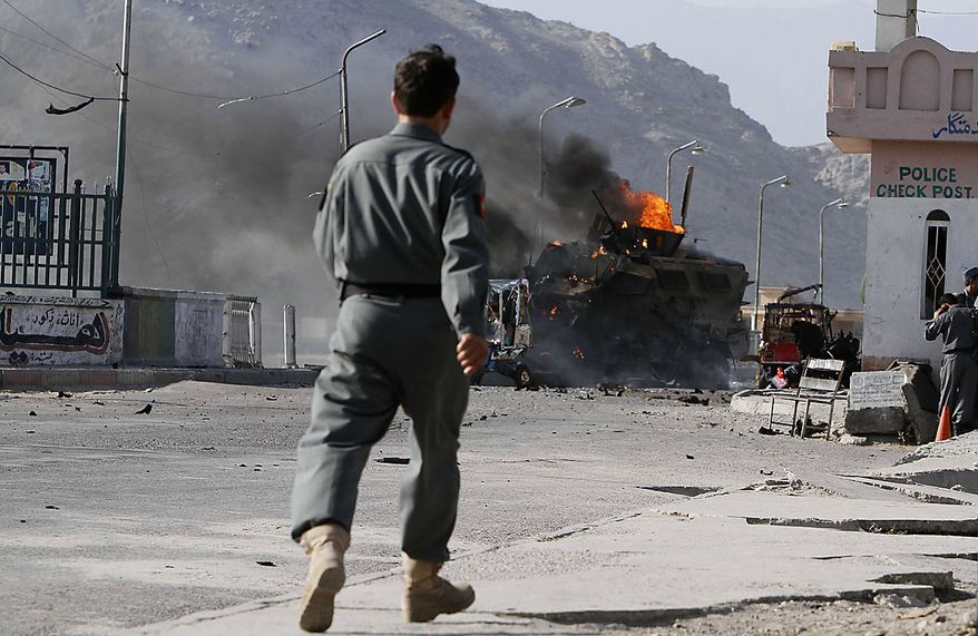 A U.S. military vehicle burns after it was hit by a blast in Jalalabad, east of Kabul, Friday, July 9, 2010. Afghan official said that a suicide car bomb hit the convoy and that one person was killed and nine were wounded. A NATO spokeswoman confirmed an explosion hit a coalition convoy but said she had been told it was a homemade bomb, not a suicide attacker. (AP Photo/Rahmat Gul)