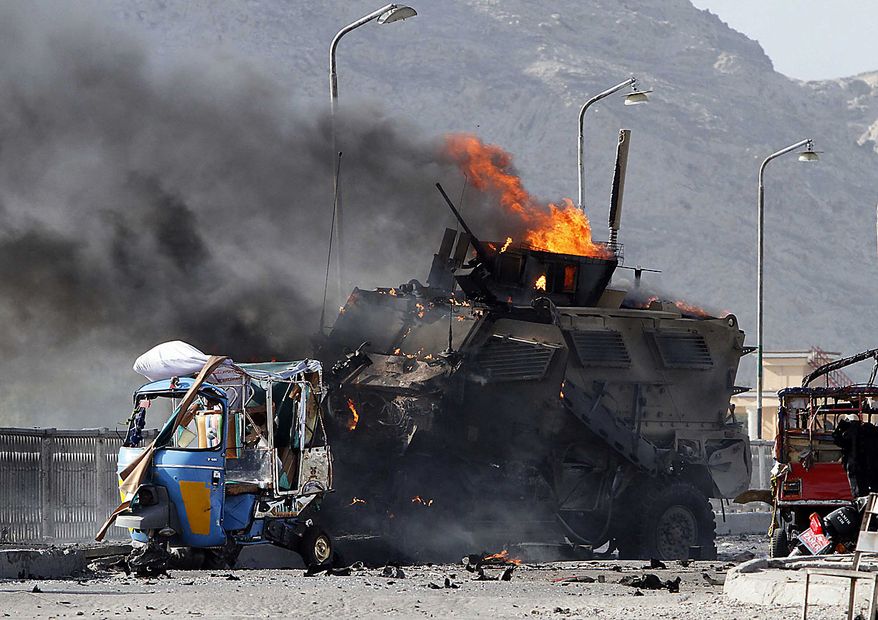 A U.S. military vehicle burns after it was hit by a blast in Jalalabad, east of Kabul, Friday, July 9, 2010. Afghan official said that a suicide car bomb hit the convoy and that one person was killed and nine were wounded. A NATO spokeswoman confirmed an explosion hit a coalition convoy but said she had been told it was a homemade bomb, not a suicide attacker. (AP Photo/Rahmat Gul)
