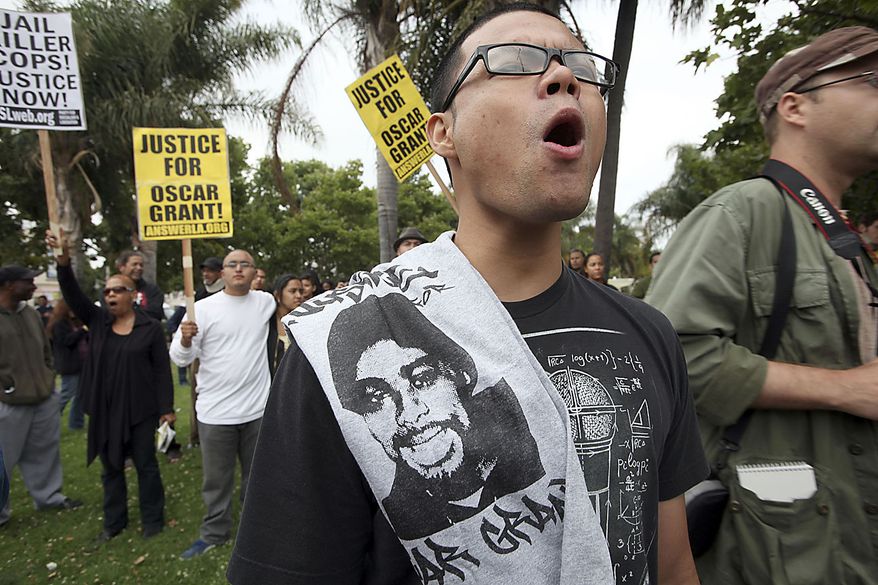 Jay Eusantos joins others during a demonstration protesting Johannes Mehserle's involuntary manslaughter conviction Thursday, July 8, 2010 in Los Angeles. Mehserle was on trial for murder in the shooting death of an unarmed black man on an Oakland train platform in a 2009 encounter that set off days of rioting in the city. (AP Photo/Nick Ut)