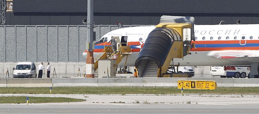 A Russian plane believed to be carrying candidates for a 14-person spy swap as part of the largest spy swap since the Cold War is parked on the tarmac at Vienna's Schwechat airport on Friday, July 9, 2010. (AP Photo/Matthias Schrader)