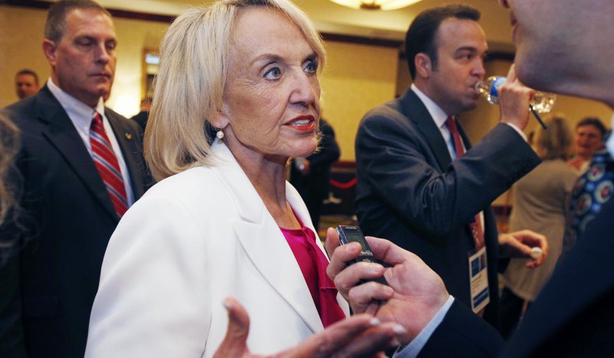Arizona Gov. Jan Brewer speaks with a reporter about her meeting with U.S. Secretary of Homeland Security Janet Napolitano at the annual meeting of the National Governors Association on Sunday, July 11, 2010, in Boston. (AP Photo/Michael Dwyer)