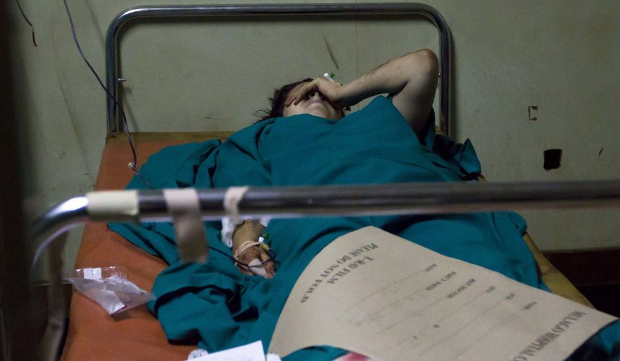 An American women lies injured in the emergency ward at the Mulago Hospital in Kampala, Uganda, on Monday, July 12, 2010, after bombs exploded at two sites in Uganda&#x27;s capital late Sunday as people watched the World Cup final on TV. The blasts killed scores of people. (AP Photo/Marc Hofer)
