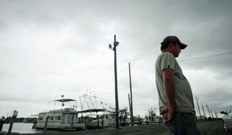 A Vietnamese oyster fisherman stands idle at the docks in Empire, La. The BP PLC oil spill has struck at the heart of the tight-knit Vietnamese community, posing hardships for those who brought their fishing traditions here as refugees. (Associated Press)