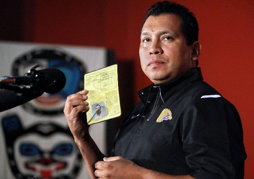 ASSOCIATED PRESS
Percy Abrams, executive director of the Iroquois Nationals lacrosse team board of directors, shows his Iroquois Confederacy passport Wednesday in New York. The British government refused to let the lacrosse team travel to Britain using Iroquois Confederacy passports.