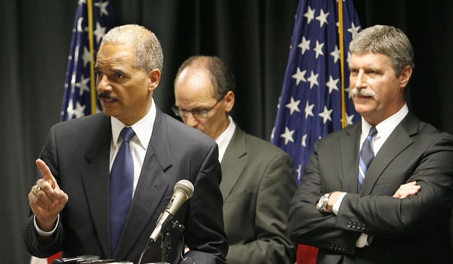 U.S. Attorney General Eric Holder speaks during a news conference announcing the indictment of six more New Orleans Police officers in the Danziger Bridge shooting and cover-up in the aftermath of Hurricane Katrina, Tuesday, July 13, 2010, at the Hale Boggs Federal Building in New Orleans. U.S. Attorney Jim Letten, is seen at right. (AP Photo/The Times-Picayune, Michael DeMocker)