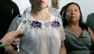 Elvira Arellano, left, an illegal immigrant from Mexico who has taken refuge in a Chicago church to avoid deportation for the last year, stands with others involved in the sanctuary movement as she answers questions at Nuestra Senora de Los Angeles church in Los Angeles Saturday, Aug. 18, 2007. (AP Photo/Reed Saxon)