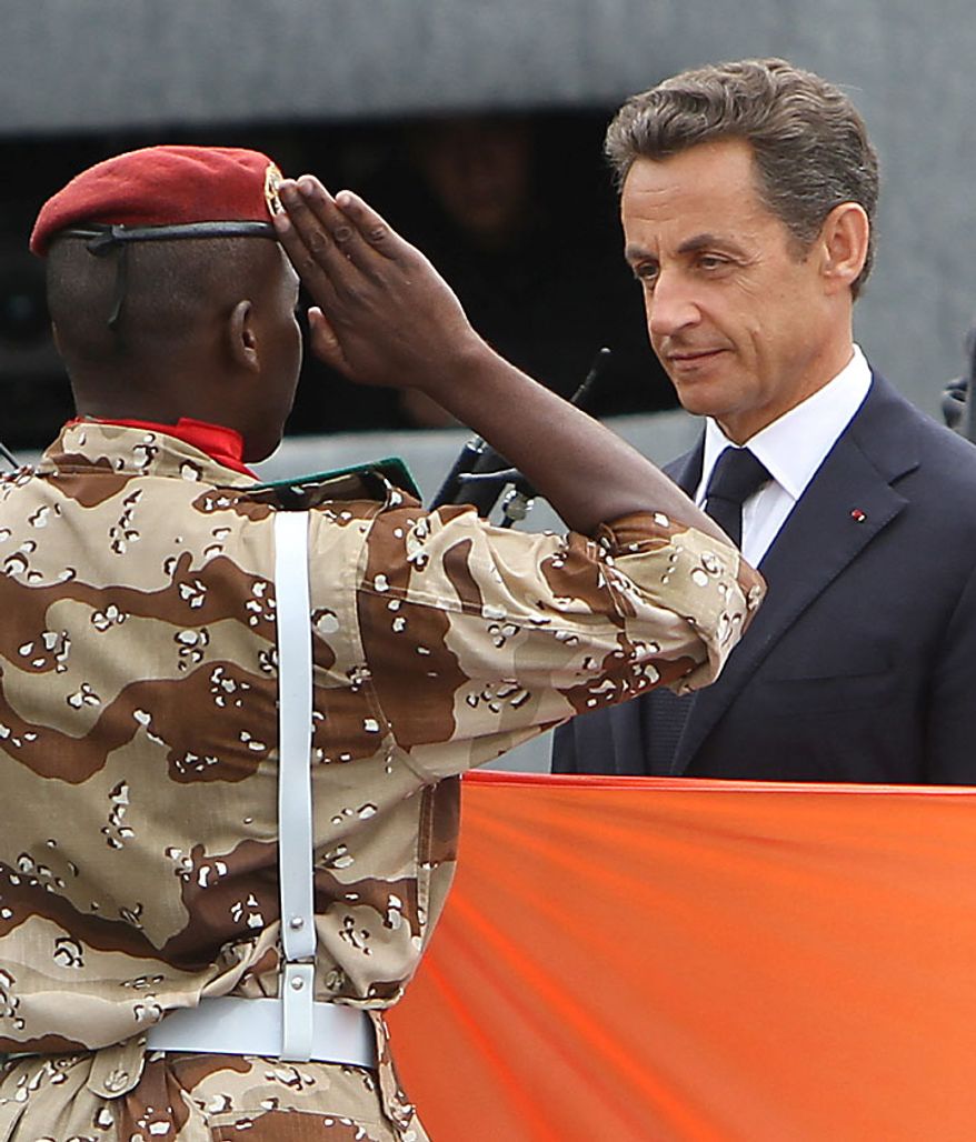French President Nicolas Sarkozy (right) is saluted by an African soldier during the annual military parade at the Place de la Concorde during the Bastille Day celebrations in Paris on Wednesday, July 14, 2010. Leaders and soldiers from 13 former French colonies in Africa, celebrating five decades of independence, were invited to take part in this year's parade. (UPI/David Silpa)