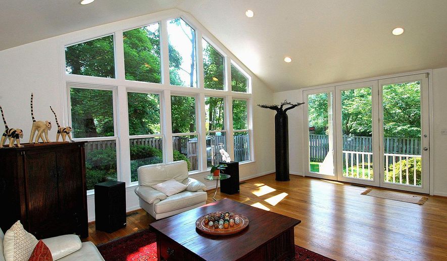 The living room features track and recessed lighting, a wood-burning fireplace and built-in cabinets.The living room features track and recessed lighting, a wood-burning fireplace and built-in cabinets.The family-room addition features a wall of windows as well as floor-to-ceiling windows on a second wall with a glass door to the deck.