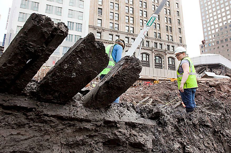 Planks stick out of the mud of a 32-foot-long (9.75 meters) 18th century boat at the World Trade Center site on Thursday, July 15, 2010 in New York. (AP Photo/Mark Lennihan)