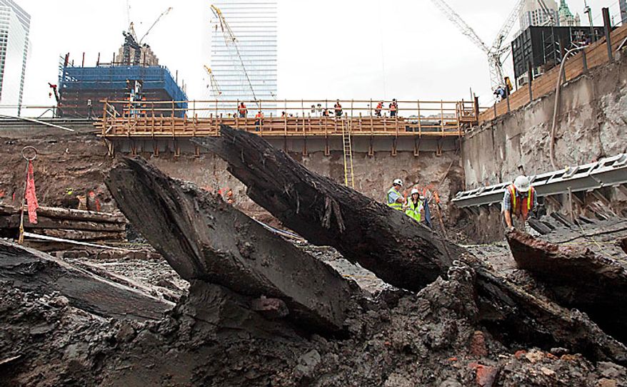 The curved ribs of a wood hull of a 32-foot-long (9.75 meters) 18th century boat poke up from the mud at the World Trade Center site on Thursday, July 15, 2010 in New York. (AP Photo/Mark Lennihan)