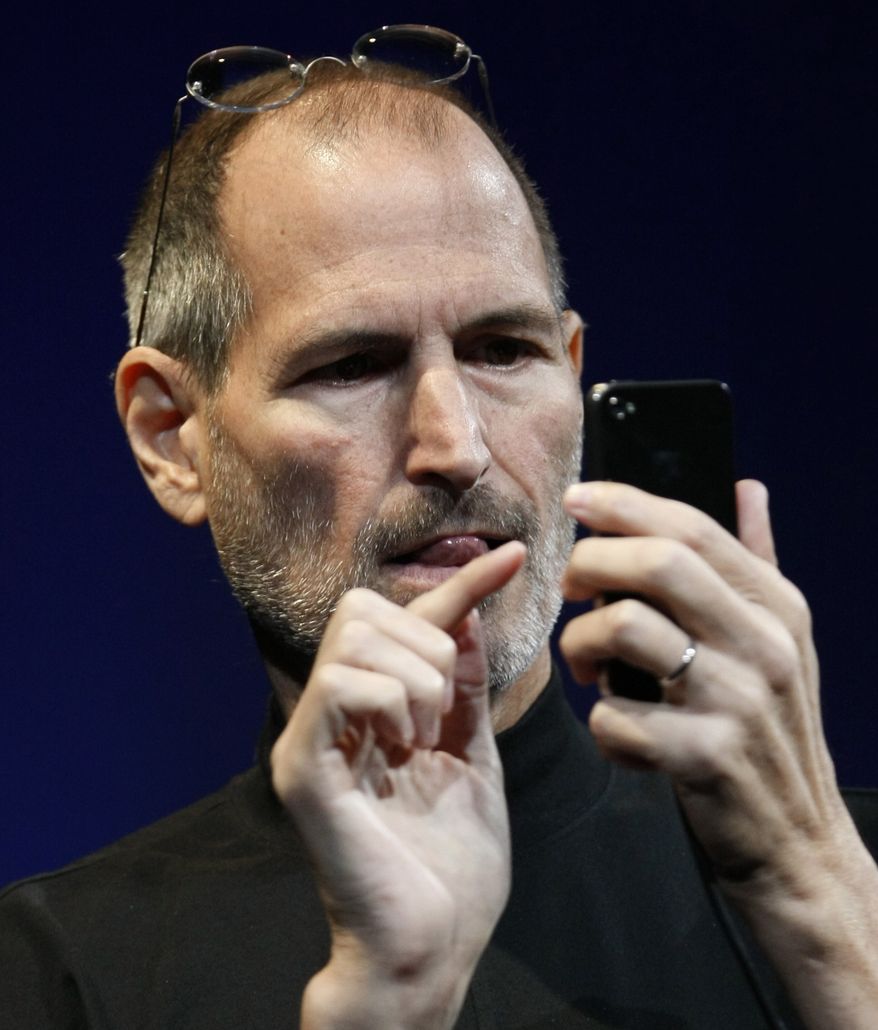 In this file photo taken June 7, 2010, Apple CEO Steve Jobs demonstrates the new iPhone 4 during the Apple Worldwide Developers Conference, in San Francisco. Apple Inc. is holding a press conference at its Silicon Valley headquarters Friday morning to talk about its latest iPhone model. (AP Photo/Paul Sakuma, File)