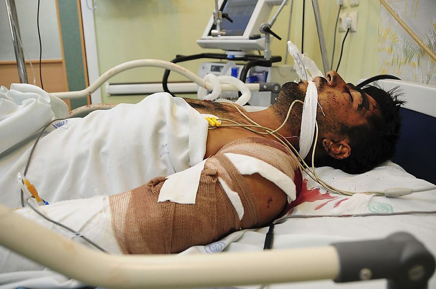 A victim of Thursday's bomb blasts lies injured in a hospital at the Iranian city of Zahedan, 940 miles southeast of the Tehran, Friday, July 16, 2010. A Sunni insurgent group said it carried out a double suicide bombing against a Shi'ite mosque in southeast Iran to avenge the execution of its leader, as Iranian authorities Friday said the death toll rose to 27 people, including members of the elite Revolutionary Guard. (AP Photo/Fars News Agency, Ali Azimzadeh)