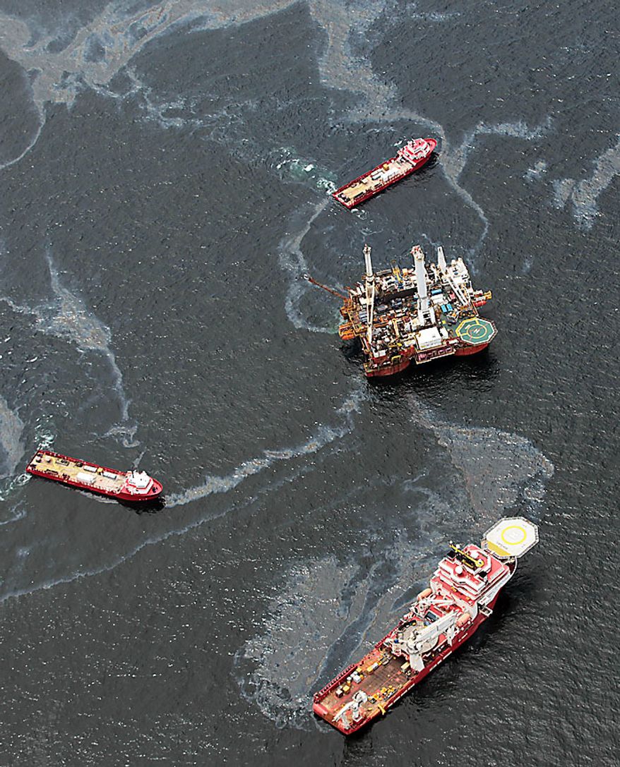 Workboats operate near the Transocean Development Drilling Rig II at the site of the Deepwater Horizon incident in the Gulf of Mexico Friday, July 16, 2010. The wellhead has been capped and BP is continuing to test the integrity of the well before resuming production. (AP Photo/Dave Martin)