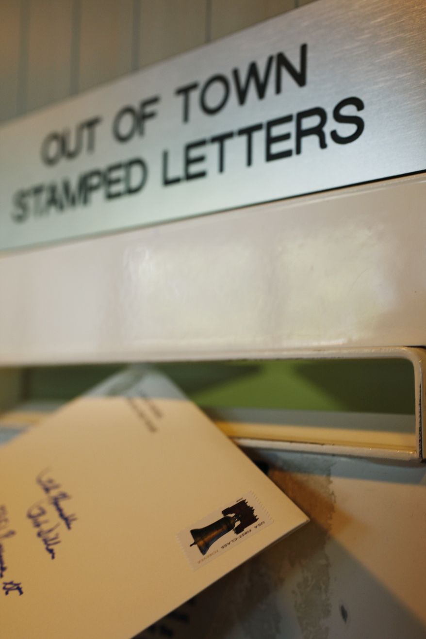 **FILE** In this photo from May 11, 2009, a letter is mailed from a post office in Palo Alto, Calif. (Associated Press)