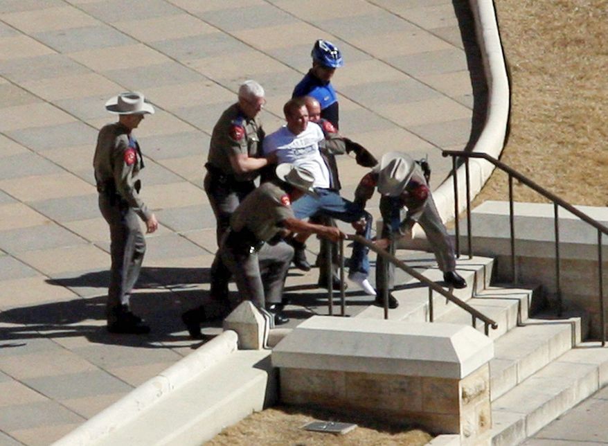 ASSOCIATED PRESS PHOTOGRAPHS
Authorities detain a man suspected of firing a gun outside the main entrance to the Texas Capitol on Jan. 21. No one was harmed, but metal detectors were installed in May.