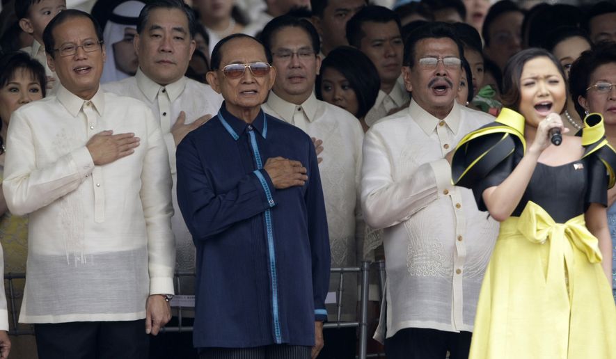 President Benigno Aquino III, left, former President Fidel Ramos, 2nd left, and former President Joseph Estrada, second right, join as Charice Pempengco sings the national anthem during the inauguration ceremony Wednesday, June 30, 2010 in Manila, Philippines. (AP Photo/Pat Roque)