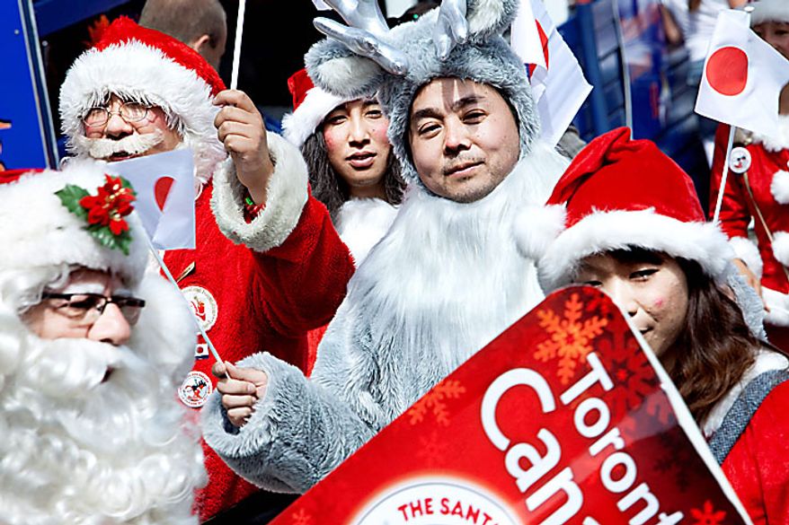 A group of Santas including a Santa and reindeer from Japan gather in the Dyrehavsbakken amusement park, north of Copenhagen, Denmark, Monday, July 19, 2010. Many have gathered for the World Santa Claus Congress, which has been held 52 times now at the amusement park. (AP Photo/Polfoto, Nanna Kreutzmann) 