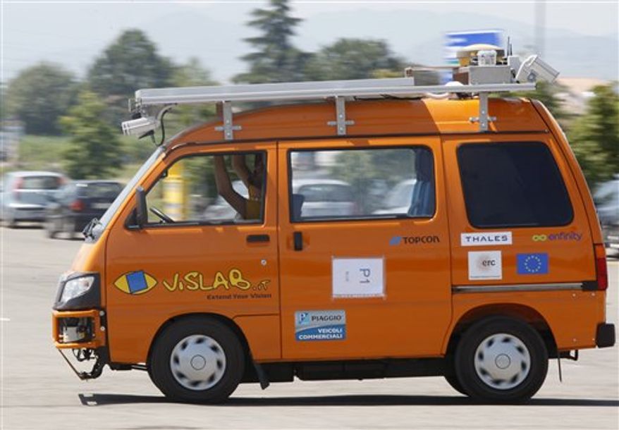 FILE - In this Thursday, July 15, 2010 file photo a technician works in an unmanned electric-powered vehicle as it makes its way in a street in Parma, Italy. A pair of fender-benders, two technology-loving hitchhikers and 22 hours blocked at the Russian border. That's the balance sheet one month into the three-month journey for a team of driverless vehicles on a 13,000-kilometer (8000-mile) road trip from Europe to China. "We were trapped in customs for one long day. We had a small accident, well two small accidents, caused by human error. As far as the technology is concerned, everything has been smooth. We are very happy,'' project leader Alberto Broggi said Tuesday, Aug. 24, 2010. (AP Photo/Antonio Calanni, file)