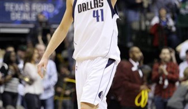 FILE - In this March 5, 2010, file photo, Dallas Mavericks forward Dirk Nowitzki, of Germany, acknowledges cheers from fans following an NBA basketball game against the Sacramento Kings in Dallas. The Mavericks announced Monday, July 19, 2010, that Nowitzki has signed a new contract with team. The agreement was reached earlier in the month. (AP Photo/Tony Gutierrez, File)