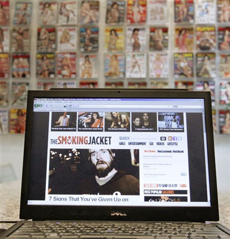 In this photo taken July 15, 2010, a laptop displays the web site the smokingjacket.com, produced by Playboy Enterprises at the company headquarters in Chicago. Playboy says the web site is safe to look at while at work _ welcome news for men tired of throwing themselves over their computer screens whenever the boss walks by. (AP Photo/M. Spencer Green)