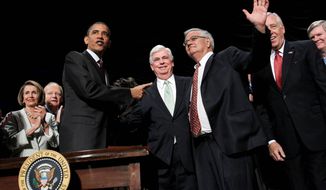 President Obama gives credit to two Democrats, Sen. Christopher J. Dodd, and Rep. Barney Frank (hand raised), after signing the Wall Street Reform and Consumer Protection Act on Wednesday. The two lawmakers chair key finance committees. At left is House Speaker Nancy Pelosi. (Associated Press)